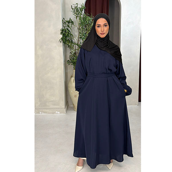 A Women wearing a Navy Satin Silk Type Fabric, called Premium Korean Nida with Zip Pockets, Elasticated Sleeves and Belt with a modal Hijab in Size 52 which fits a size 6-16