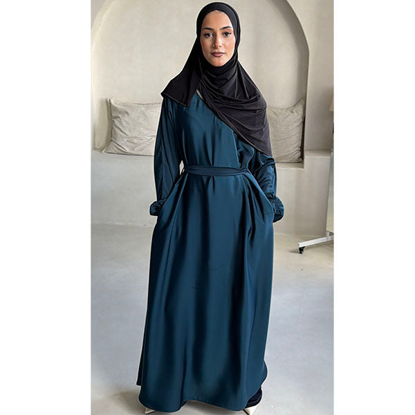 A women wearing a Teal Shiny Metallic Type Satin Material Tiktok fabric A -Line Cut Abaya  with Zip Pockets and Belt Size 54