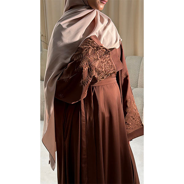 A women Wearing A brown Shiny Satin Fabric Open Button Abaya with side pockets and elegant  well detailed floral embroidery Size 52 