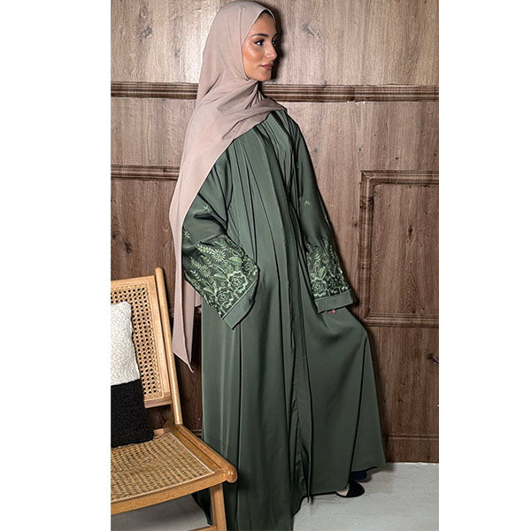 A women Wearing A Sage Shiny Satin Fabric Open Button Abaya with side pockets and elegant  well detailed floral embroidery Size 54