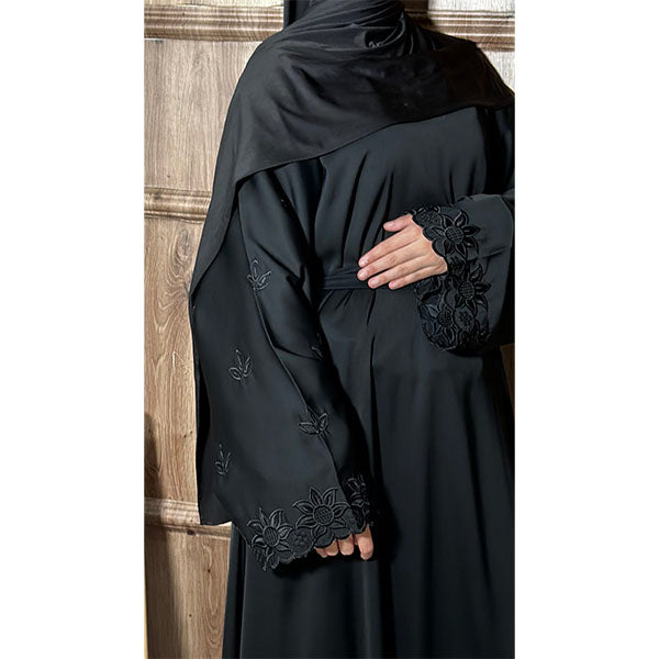 A women wearing A long Sleeve Floral Embroidered Sleeve Belted Abaya in Shiny Fabric in the colour Black
